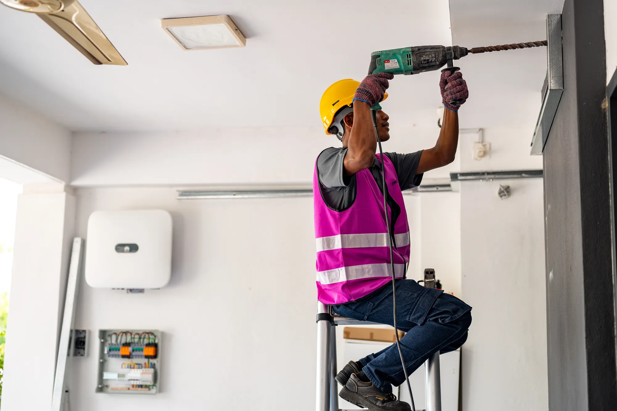 Installer mounting the inverter and PVDB