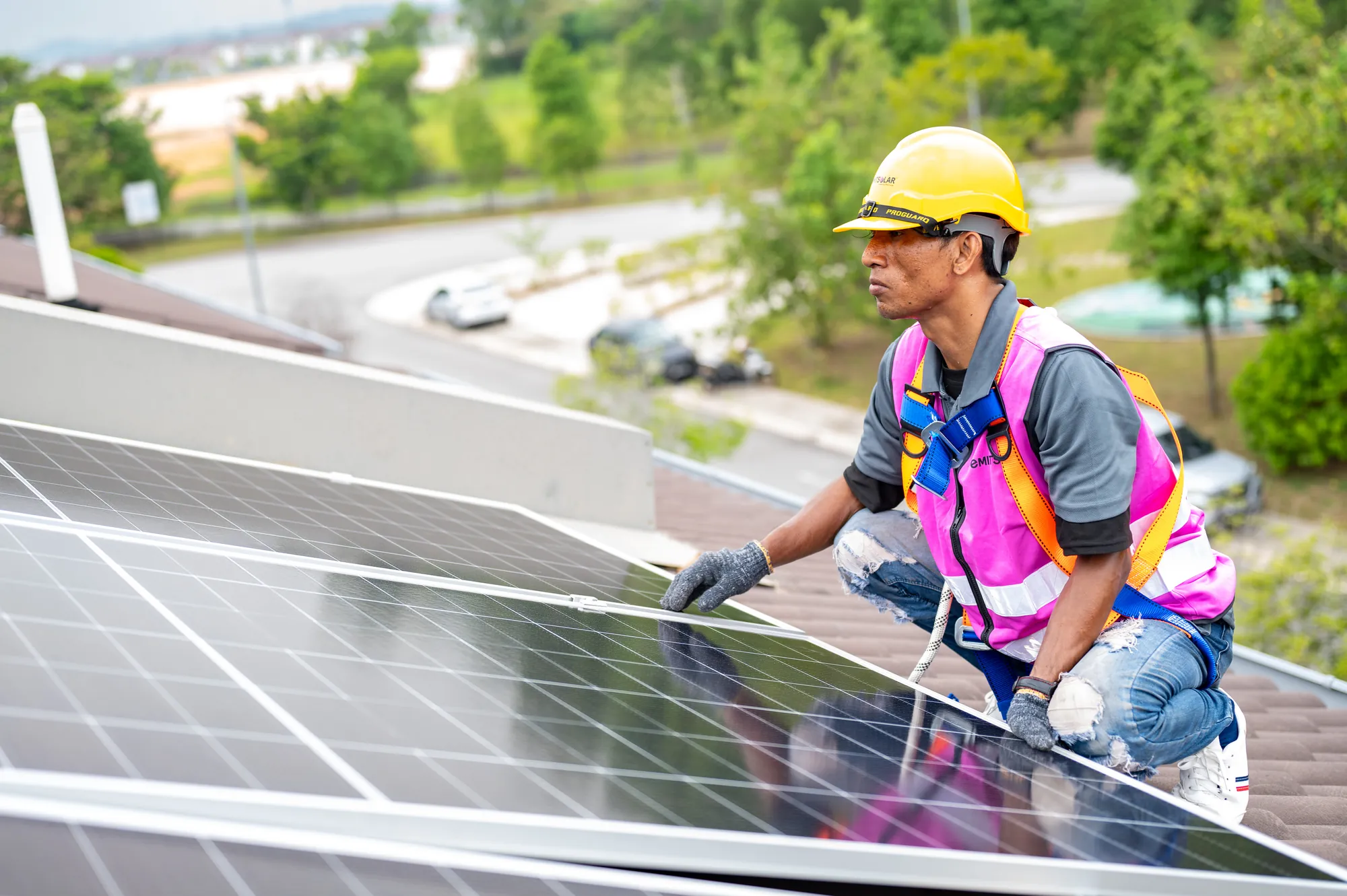 Emit Solar installer working on a rooftop array